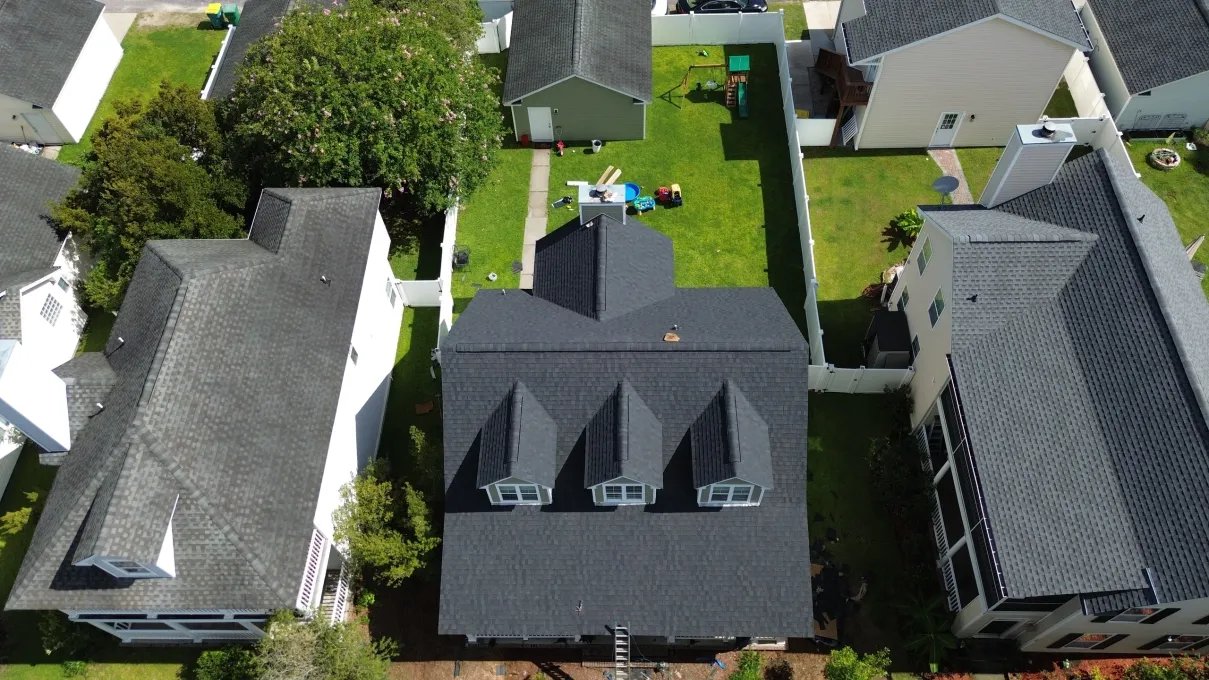 Aerial view of a newly installed dark architectural shingle roof on an Omaha-area home